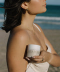 woman holding body scrub in hand